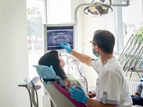 Dentist showing a patient x rays of their teeth