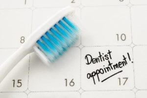 Toothbrush and dentist appointment on calendar 